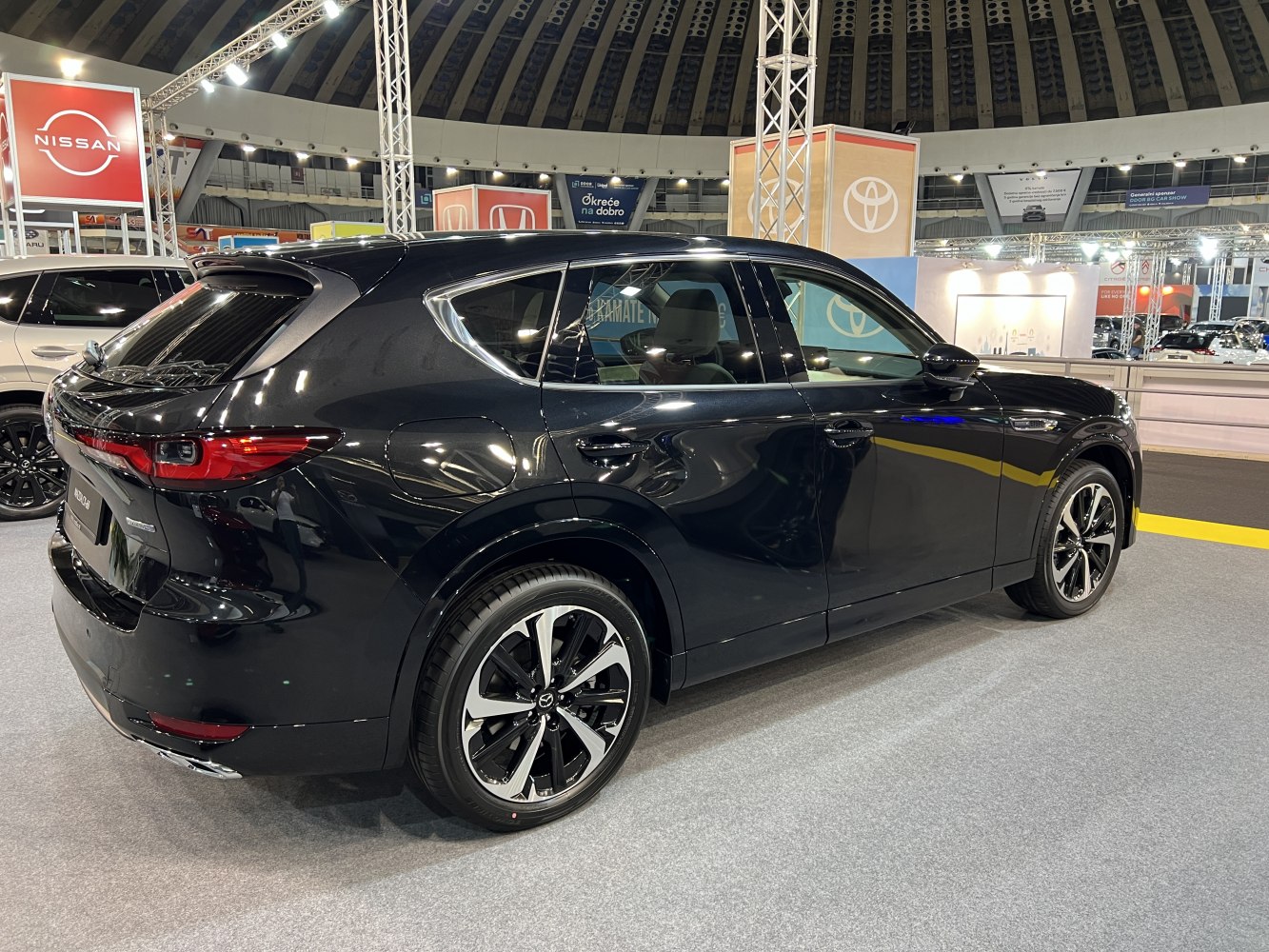 Rear side view of black SUV with alloy wheels and aerodynamic shape