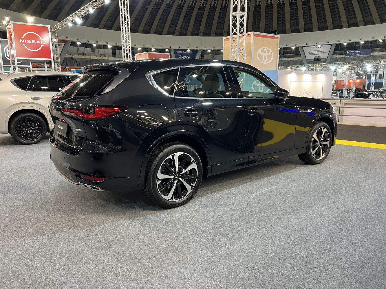 Rear side of black SUV with alloy wheels and sleek tail lights