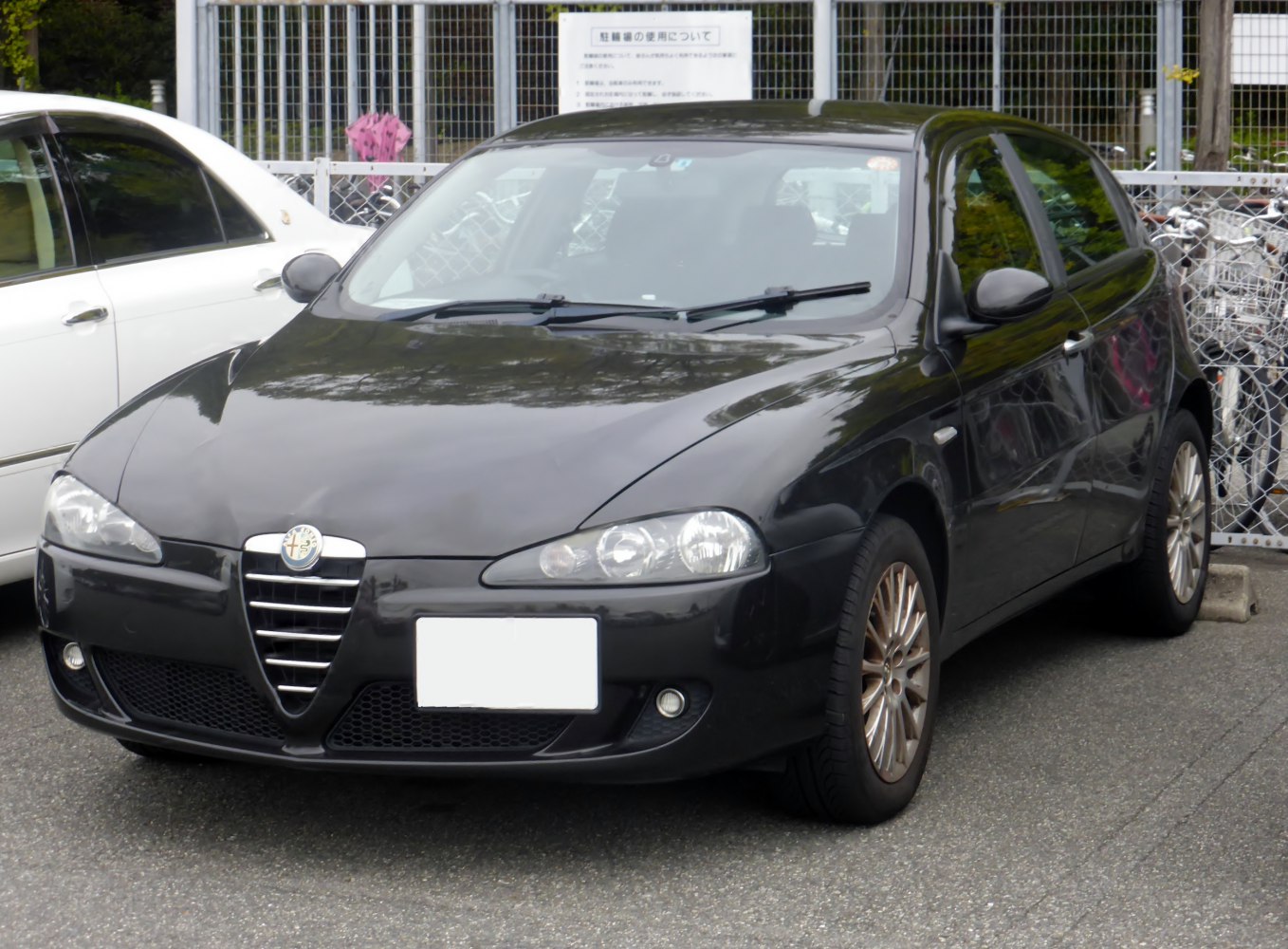 Close-up front view of black 5-door hatchback with distinct grille and headlights