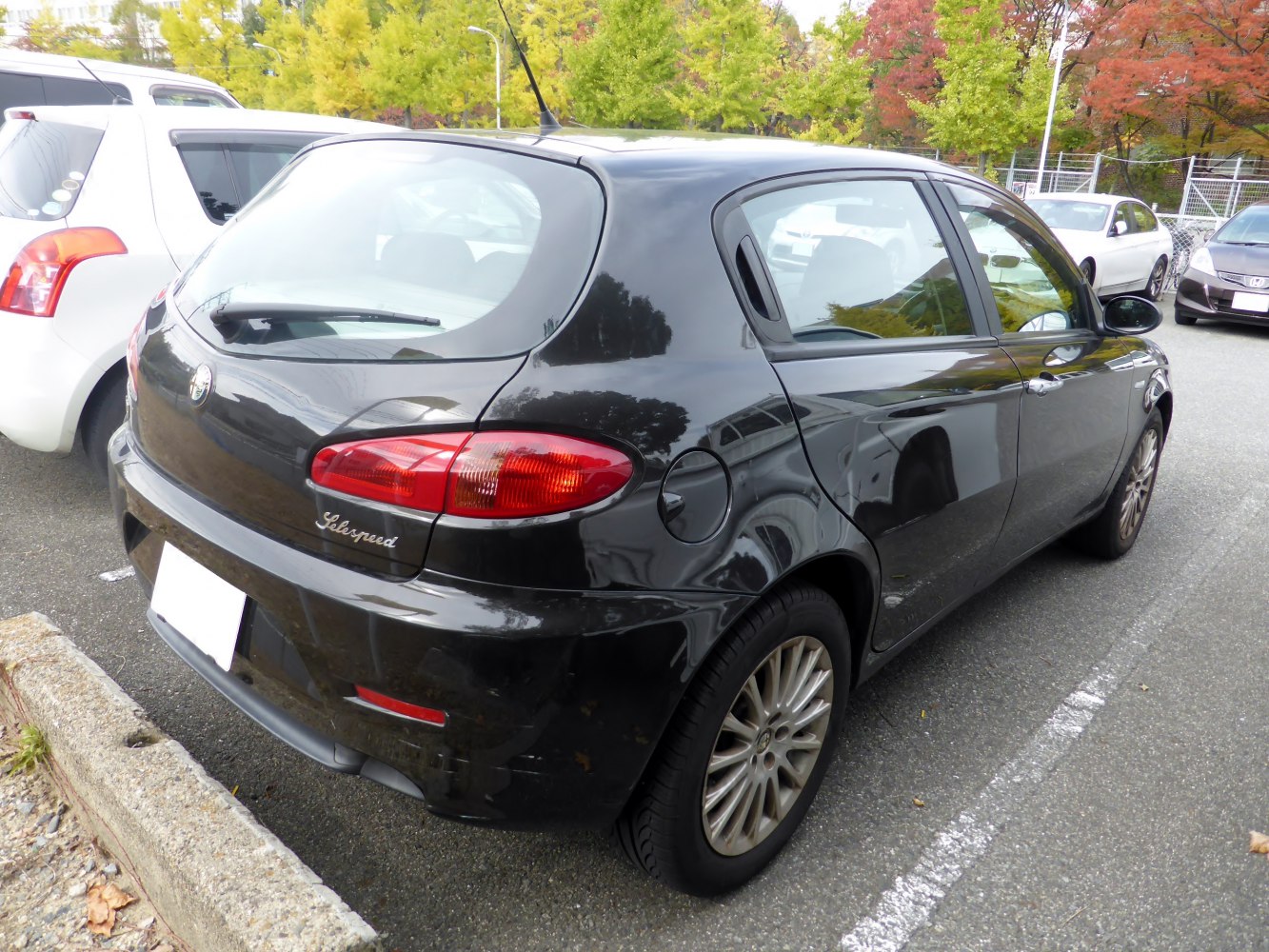 Black 5-door hatchback with rear wiper and oval tail lights.