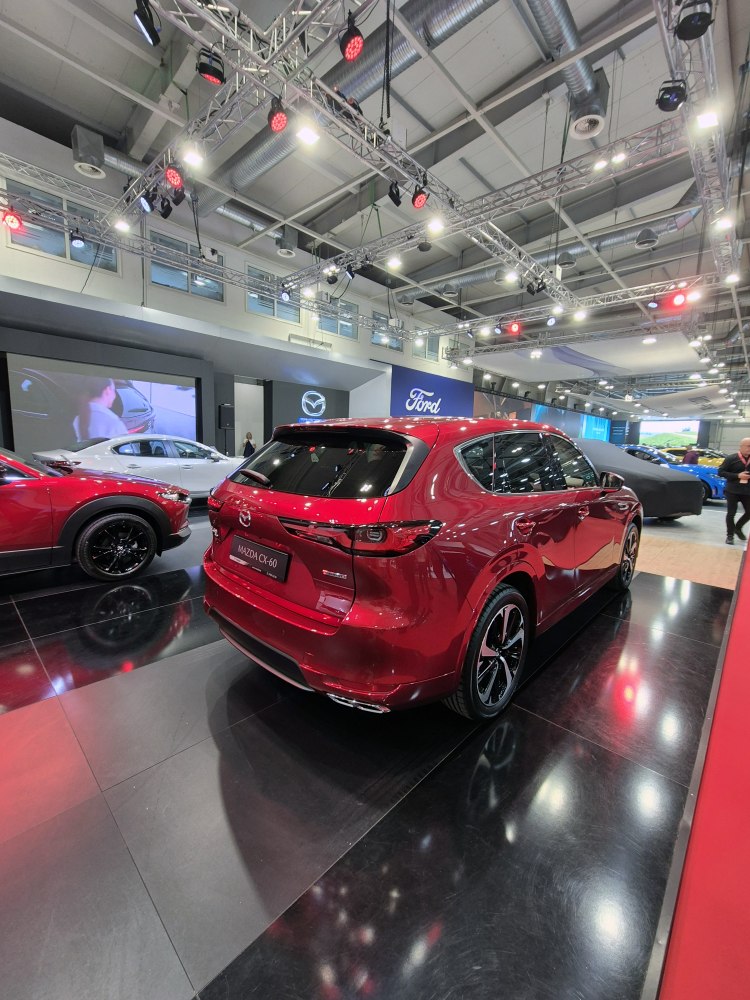 Red SUV rear and side view with sleek taillights and alloy wheels