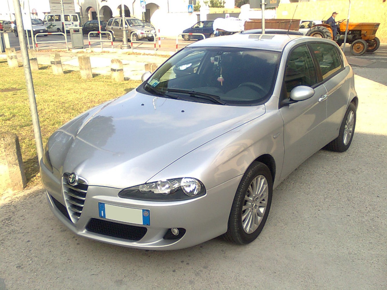 Front view of silver 5-door hatchback with distinct grille and dual headlights