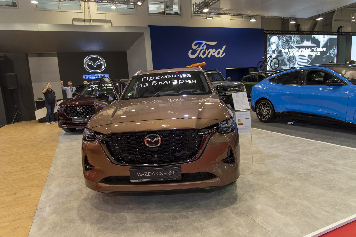 Bold front grille with sleek LED headlights of a 2024 SUV at auto show