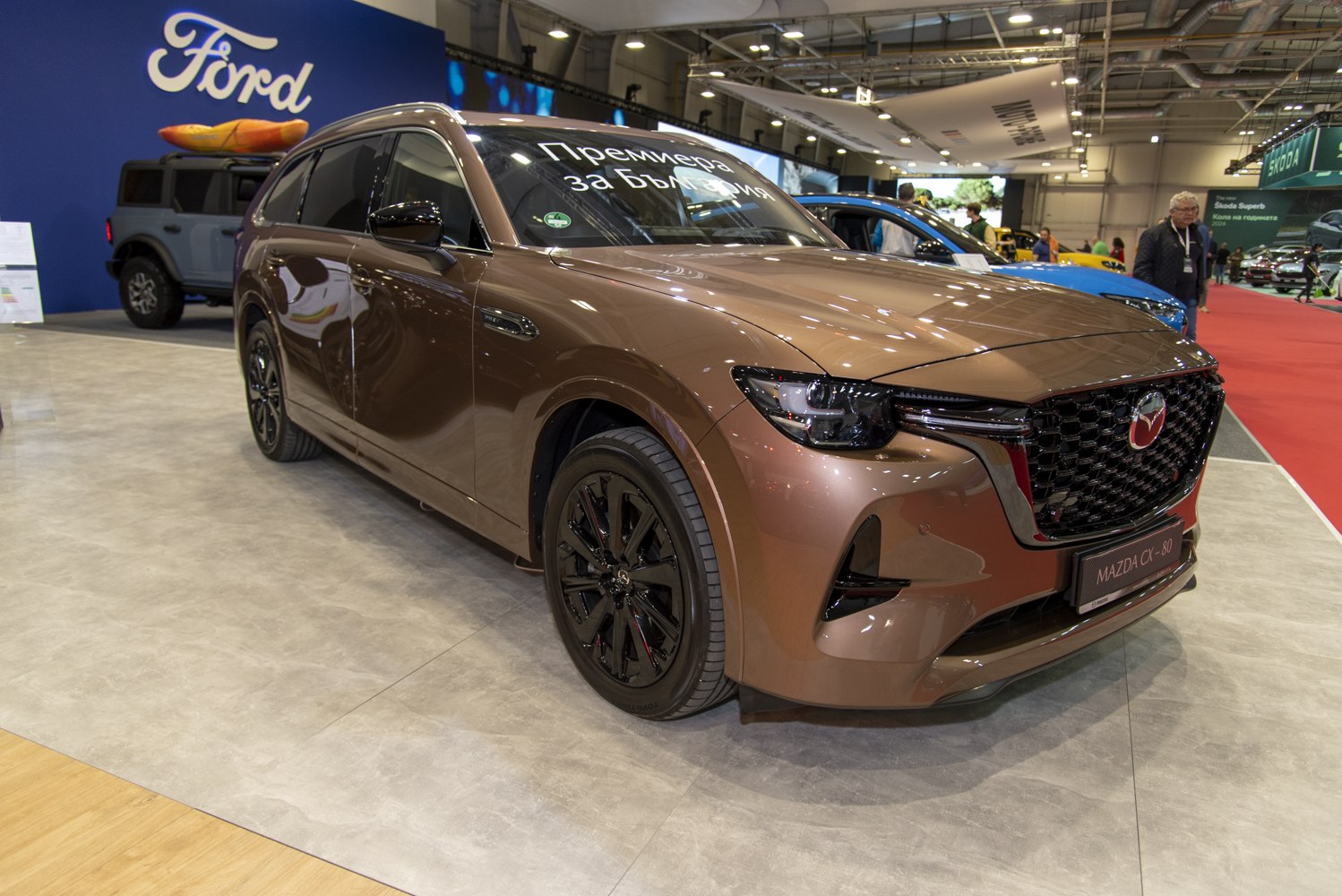 Front-side view with bold grille and black alloy wheels