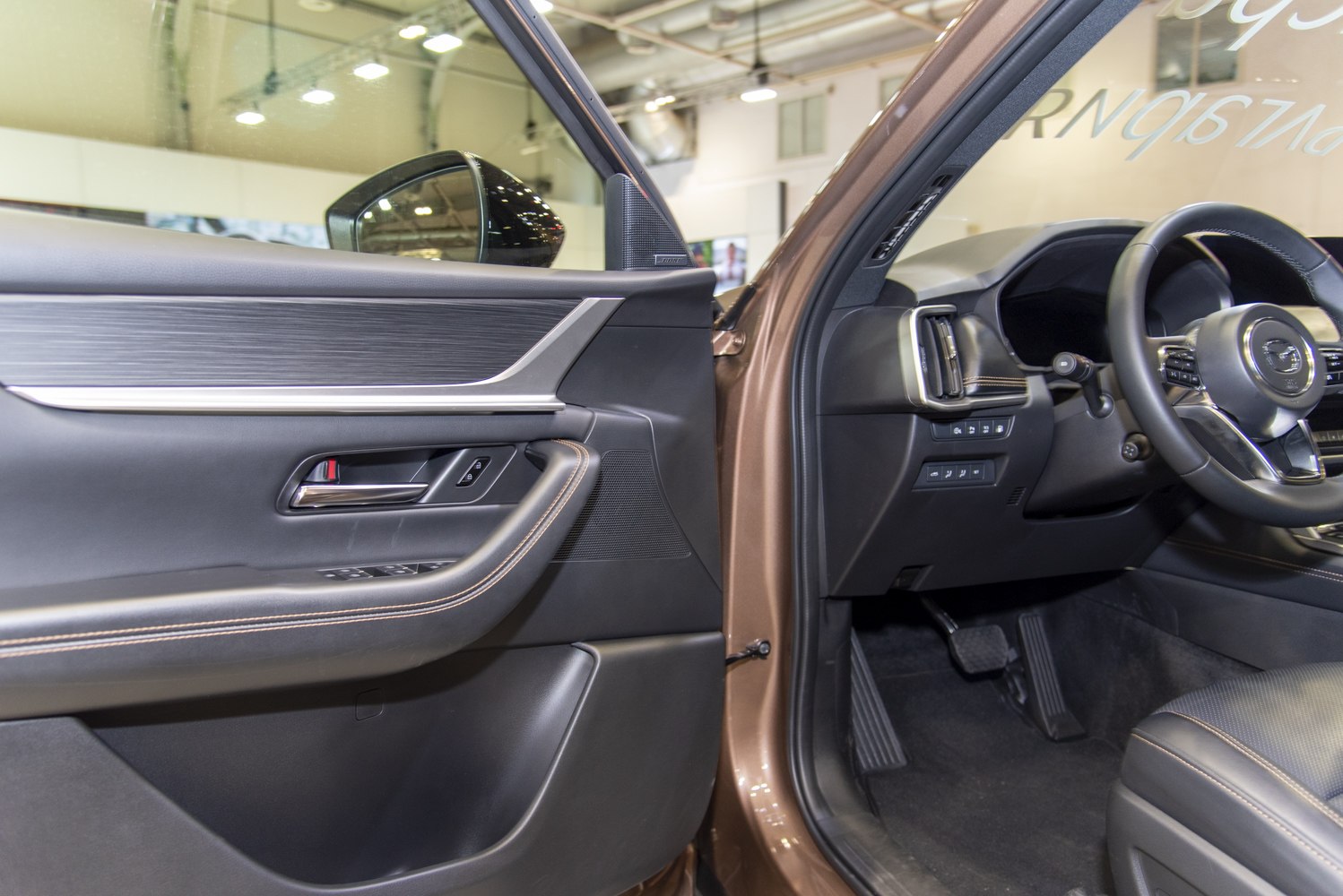 Interior door panel and driver seat area with leather trim and control buttons
