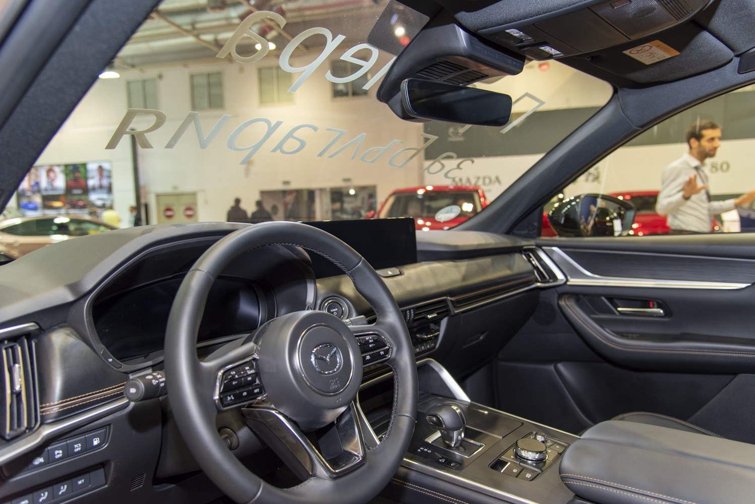 Modern car interior with dashboard, steering wheel, and center console controls