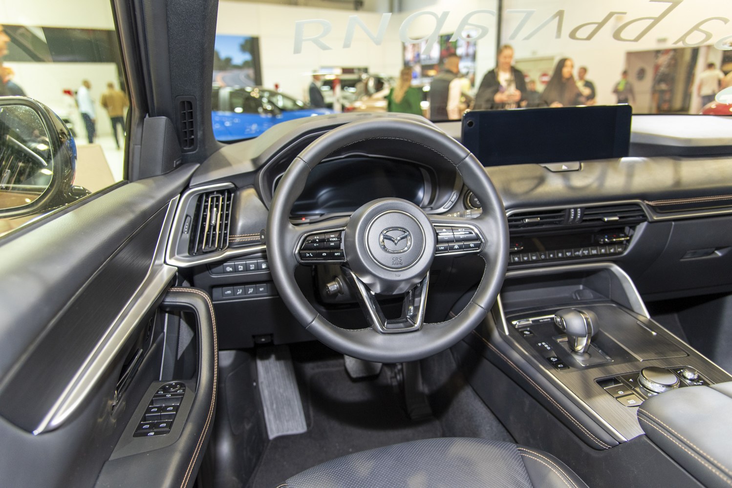 Modern car interior dashboard with leather steering wheel and infotainment screen