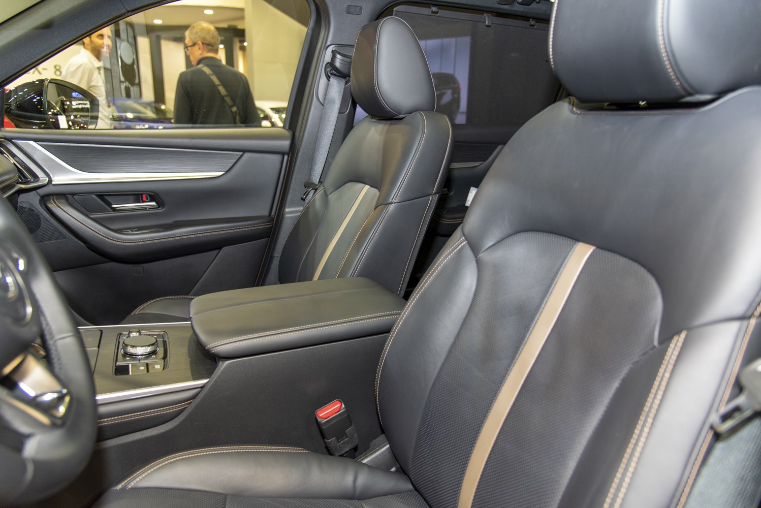 Luxury leather front seats with beige stripe and detailed stitching.
