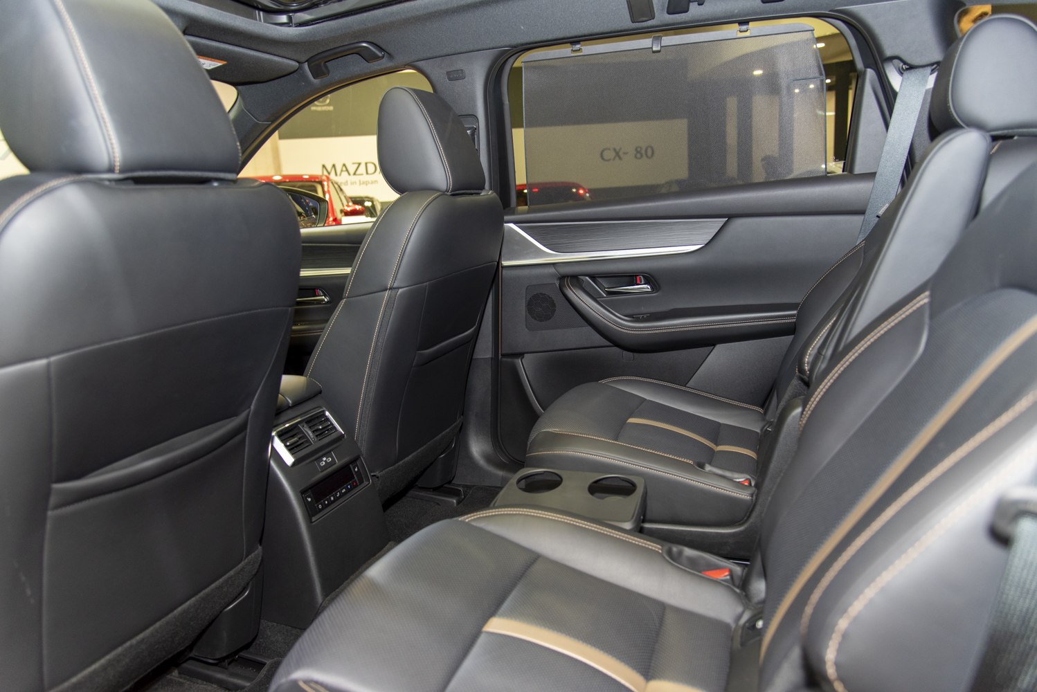 Leather rear seats with cup holders and window sunshade.