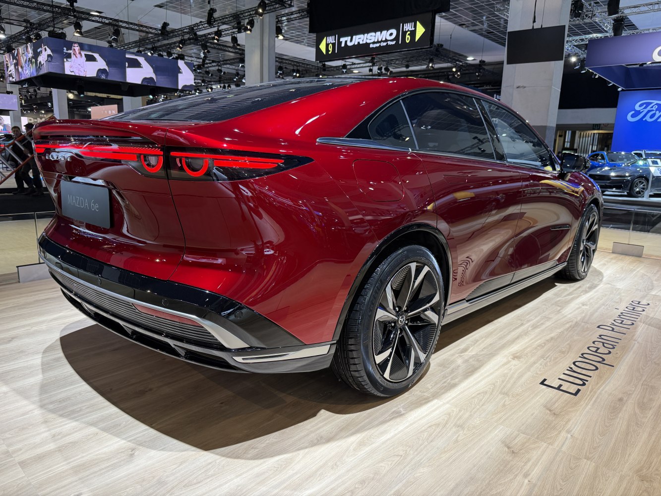 Rear and side view of a sleek electric sedan with distinctive taillights and modern wheels