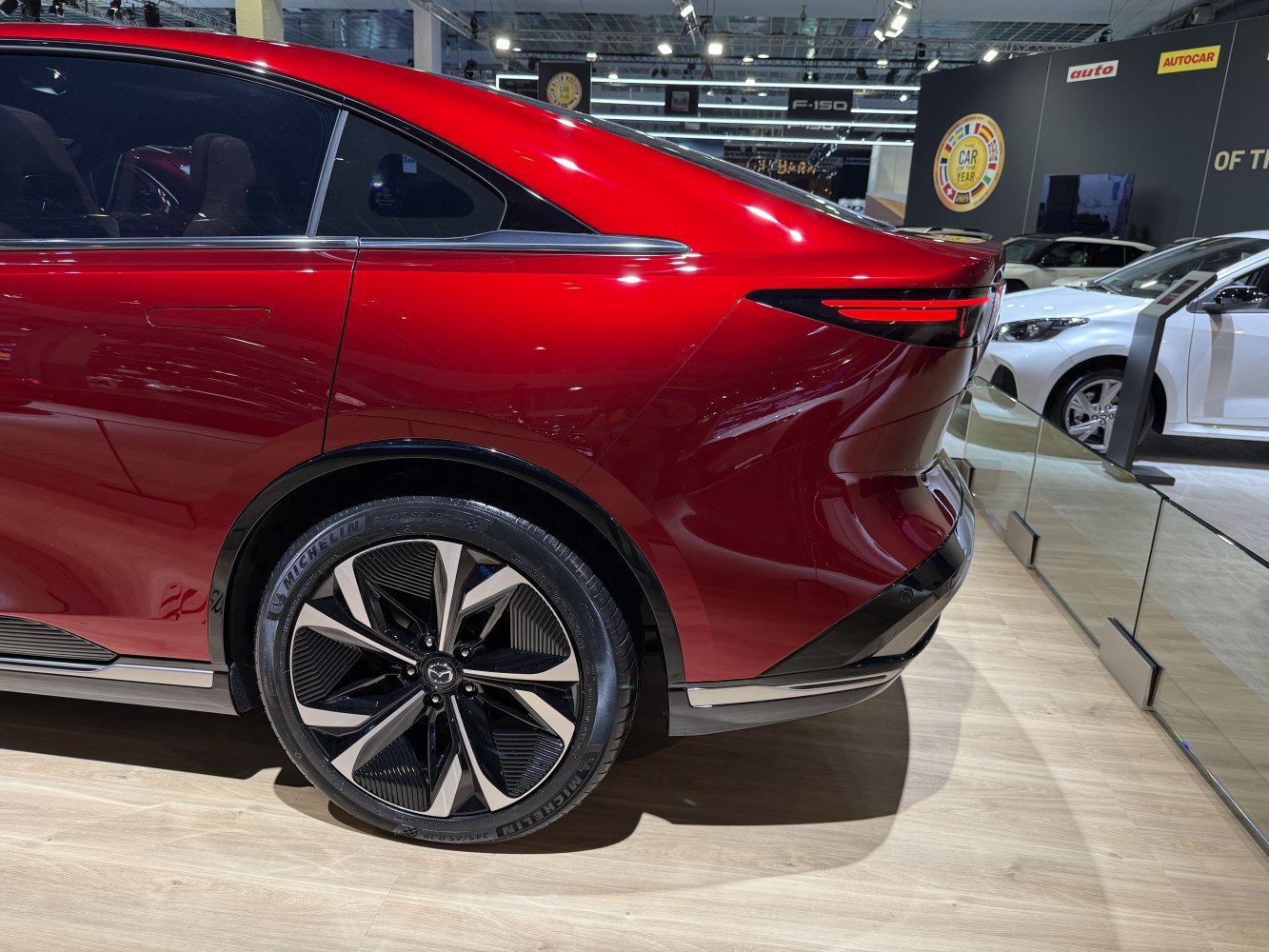 Sleek red rear with aerodynamic tail and distinctive alloy wheels