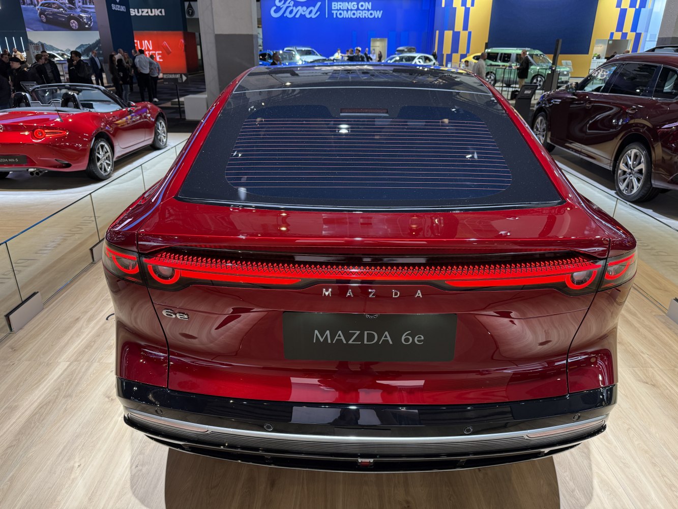 Rear view with sleek LED tail lights and a large rear window.