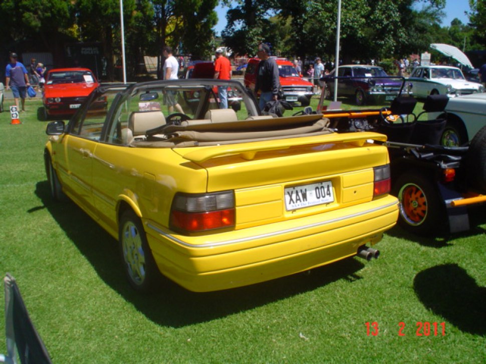 Yellow convertible with rear spoiler and rectangular tail lights