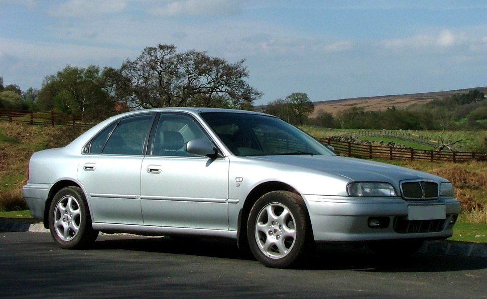 Silver four-door sedan with alloy wheels and classic 1990s design.