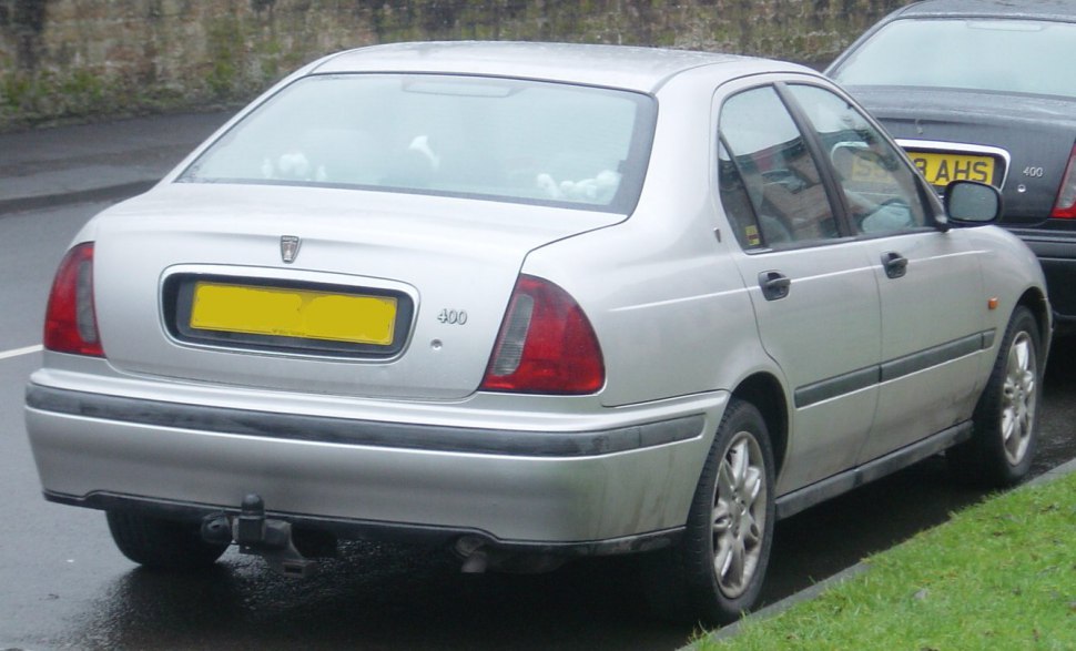 Silver sedan rear view with taillights and tow hitch