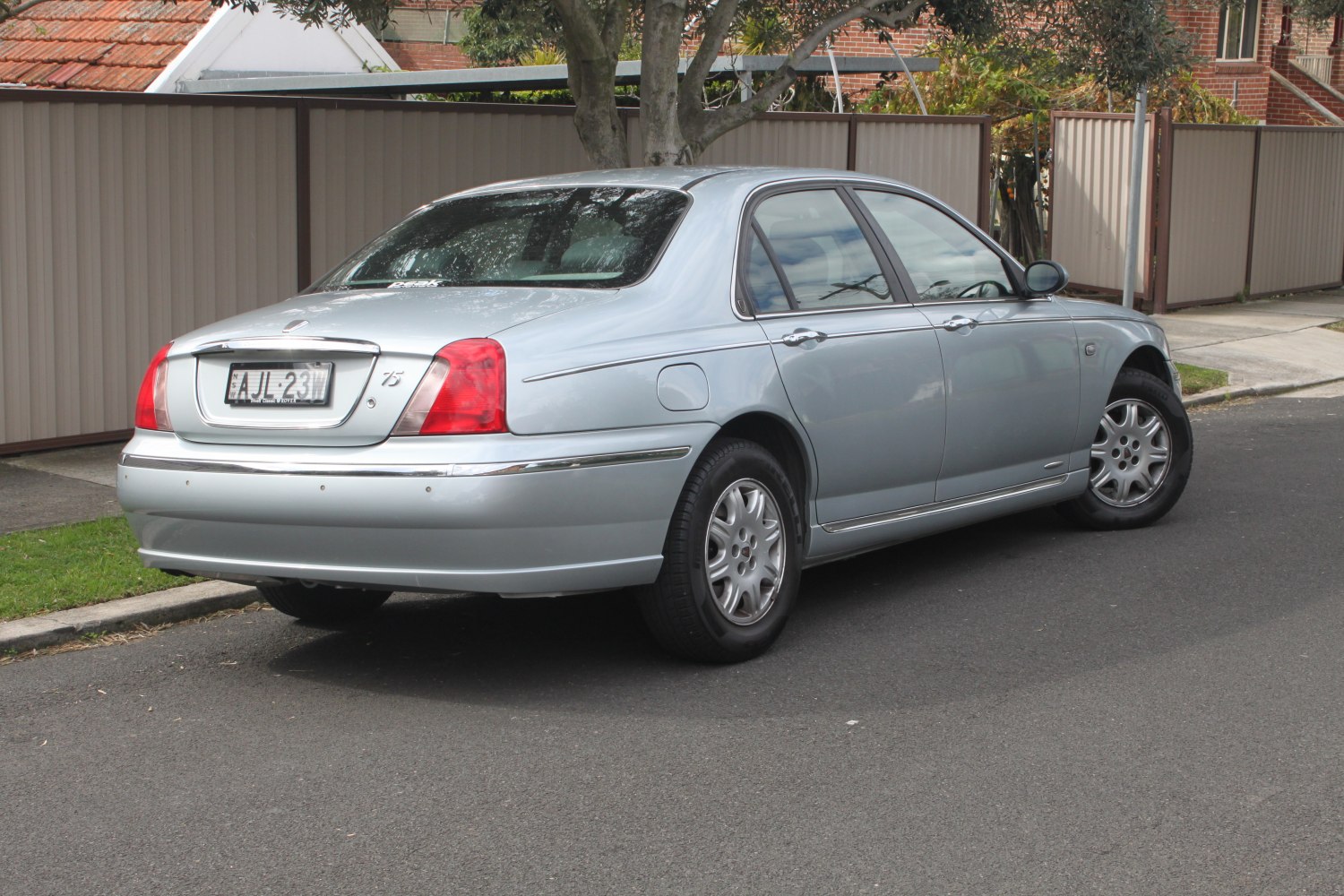 Silver sedan rear-side view with chrome trim and classic taillights
