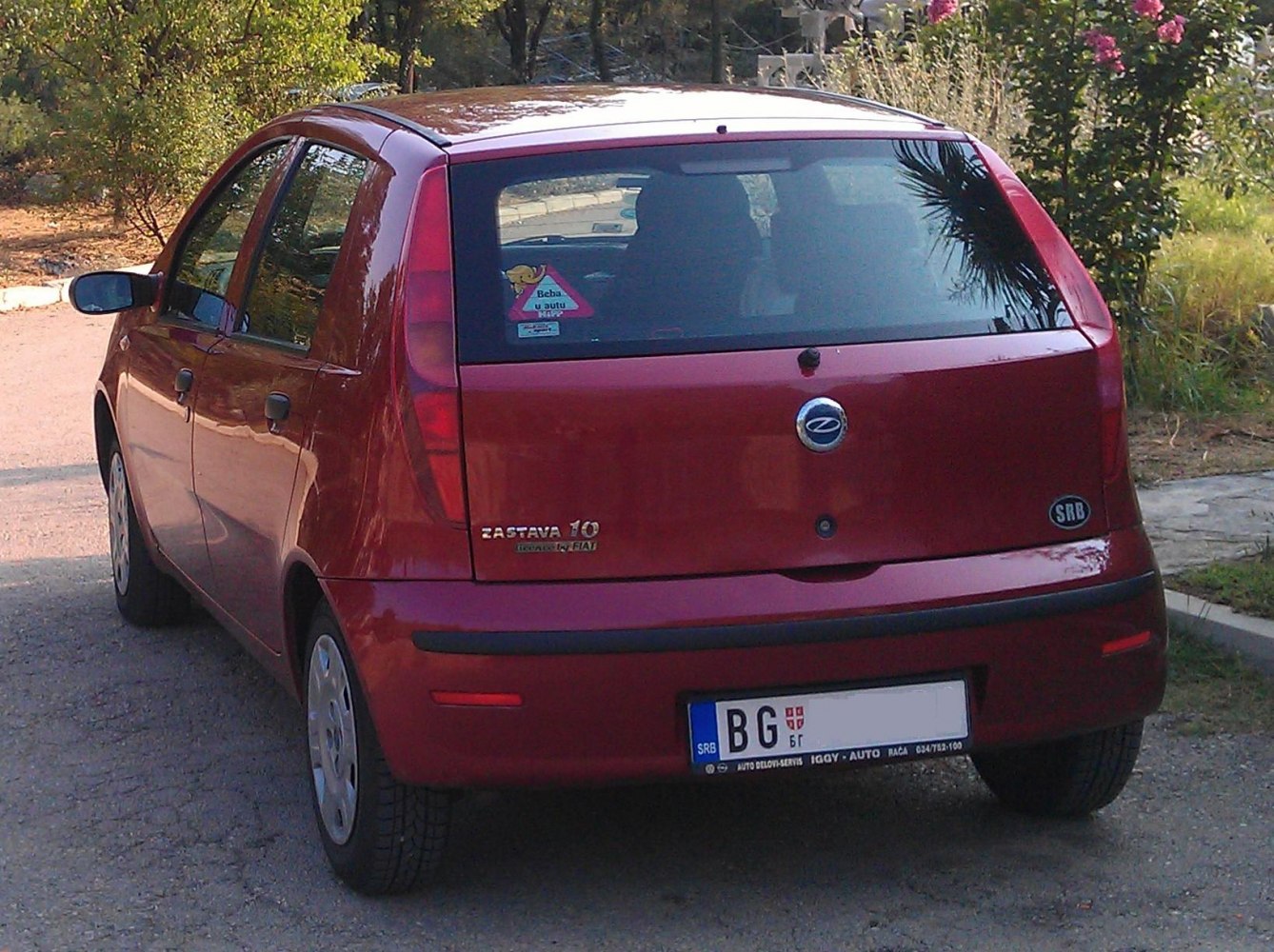 Compact hatchback rear with vertical tail lights and windshield wiper