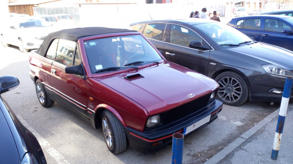 Red convertible with black soft top and sporty compact design