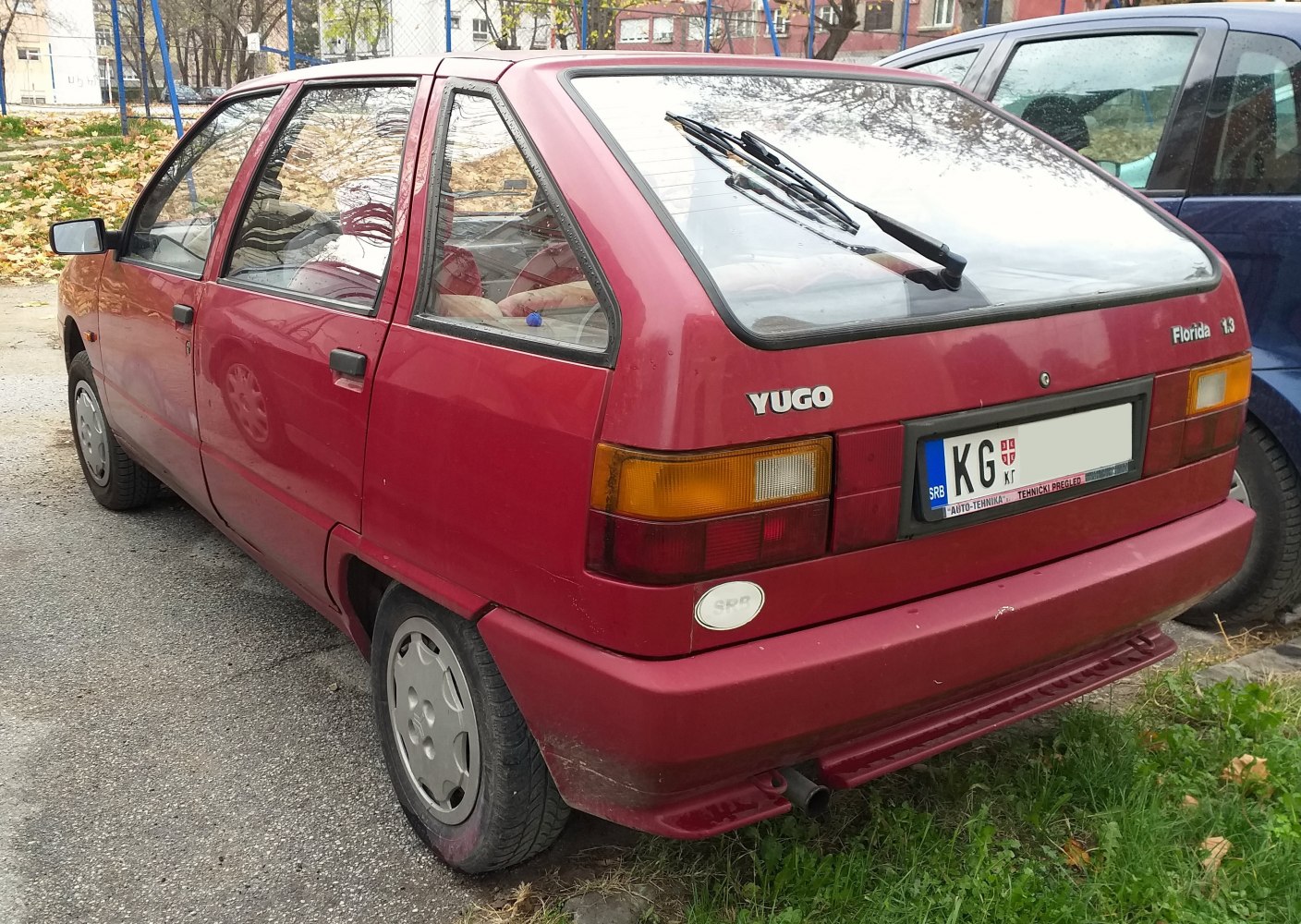Rear and side view of a compact 1990s hatchback with rear wiper