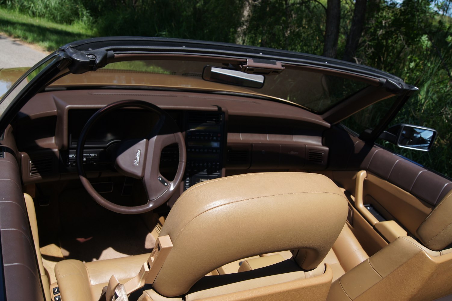 Convertible interior with brown dashboard and tan leather seats
