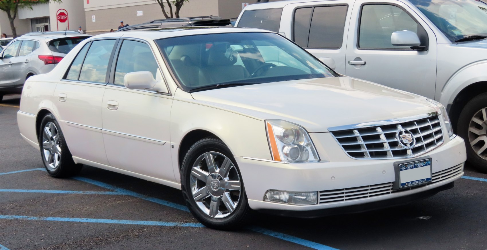 Luxury sedan front side view with chrome grille and wheels