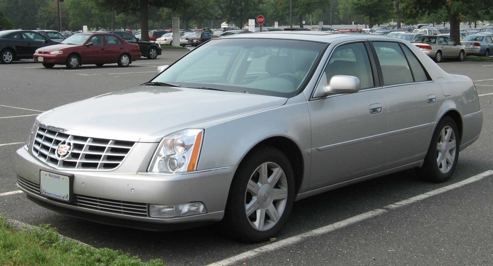 Silver full-size luxury sedan front-side with prominent grille