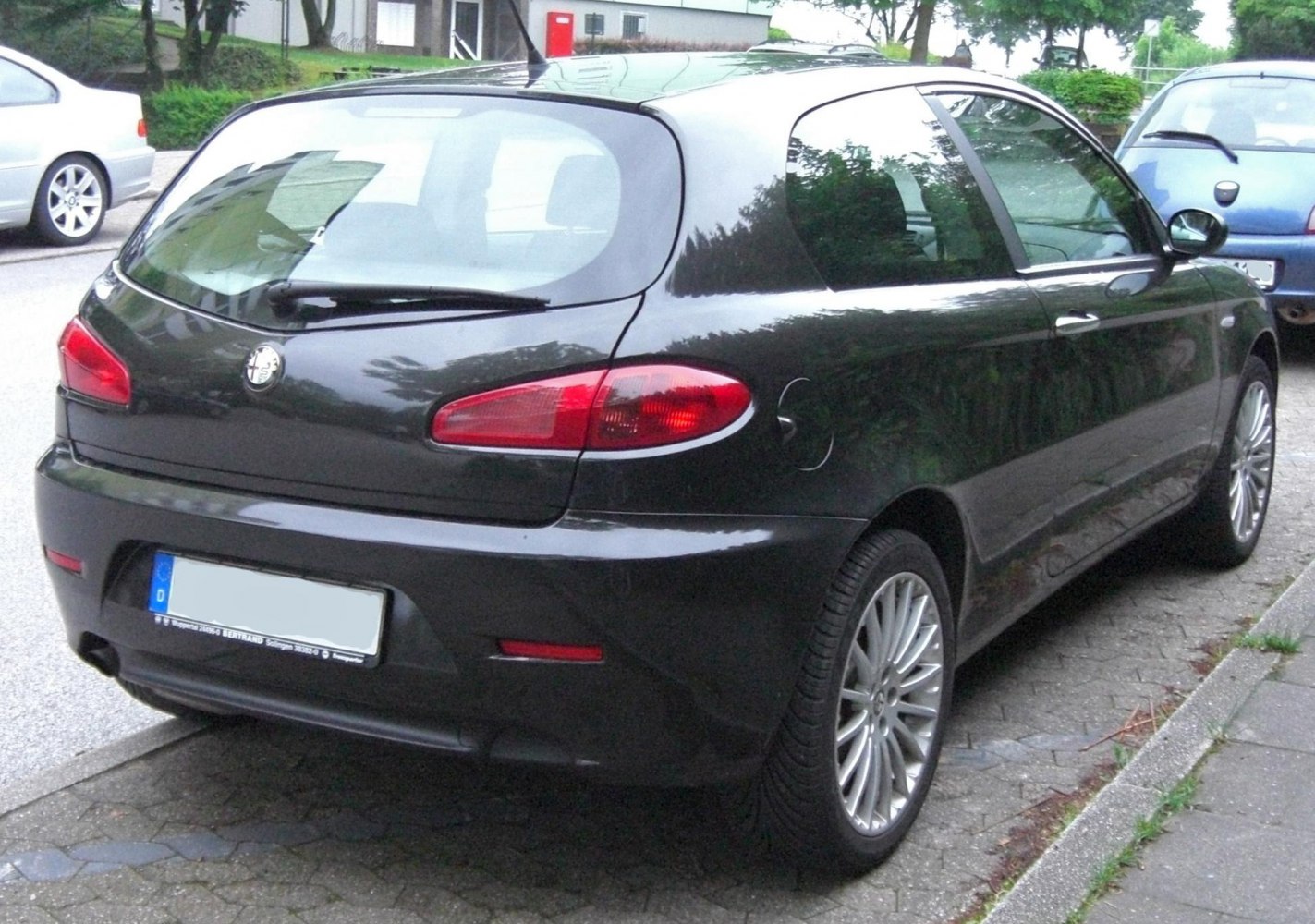 Rear view of a 3-door hatchback with distinct tail lights and alloy wheels.