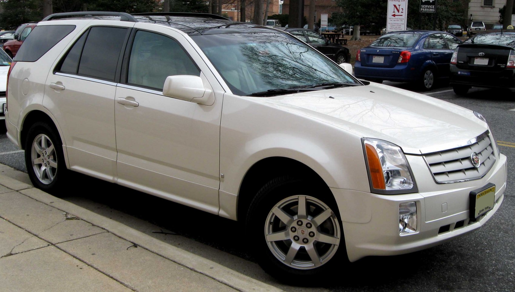Front-side view of a luxury mid-size SUV with alloy wheels and signature grille