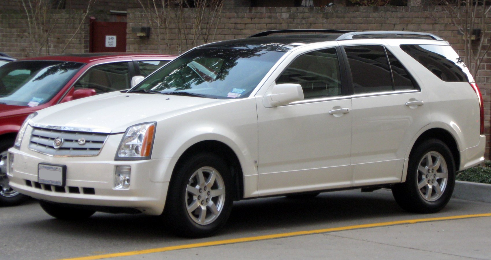 White luxury SUV with iconic grille and alloy wheels