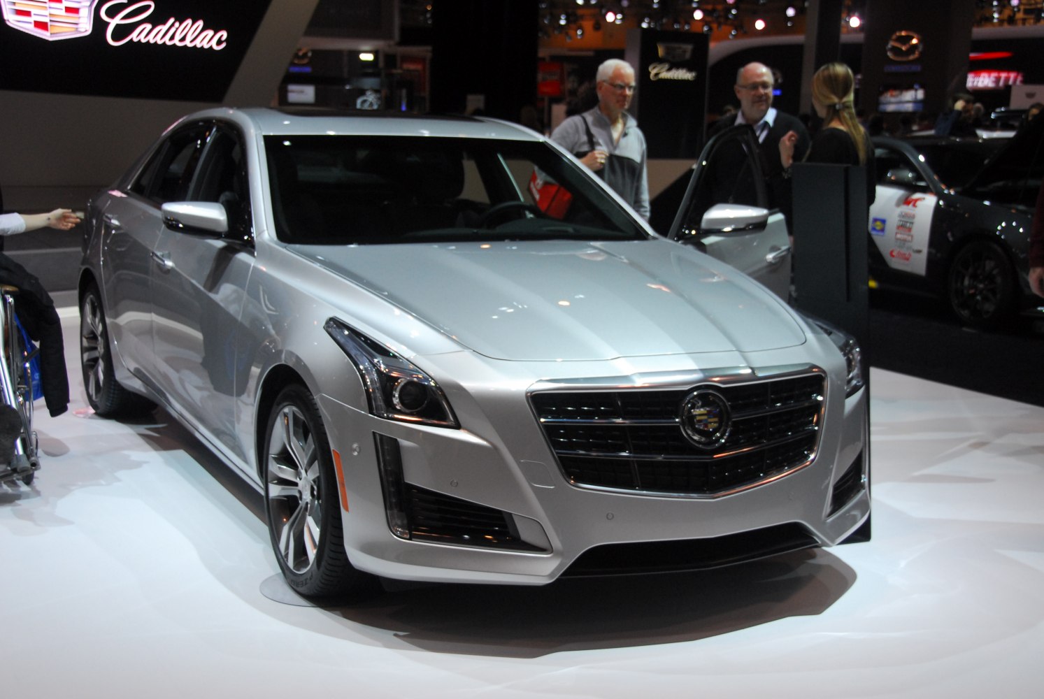 Silver luxury sedan front view with LED headlights and prominent grille