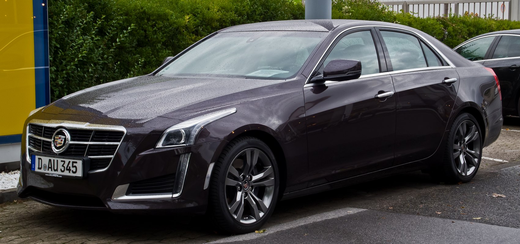 Front-side view of a luxury sedan with LED headlights and alloy wheels