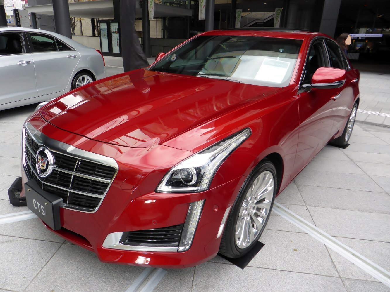 Front view of luxury sedan with LED headlights and chrome grille