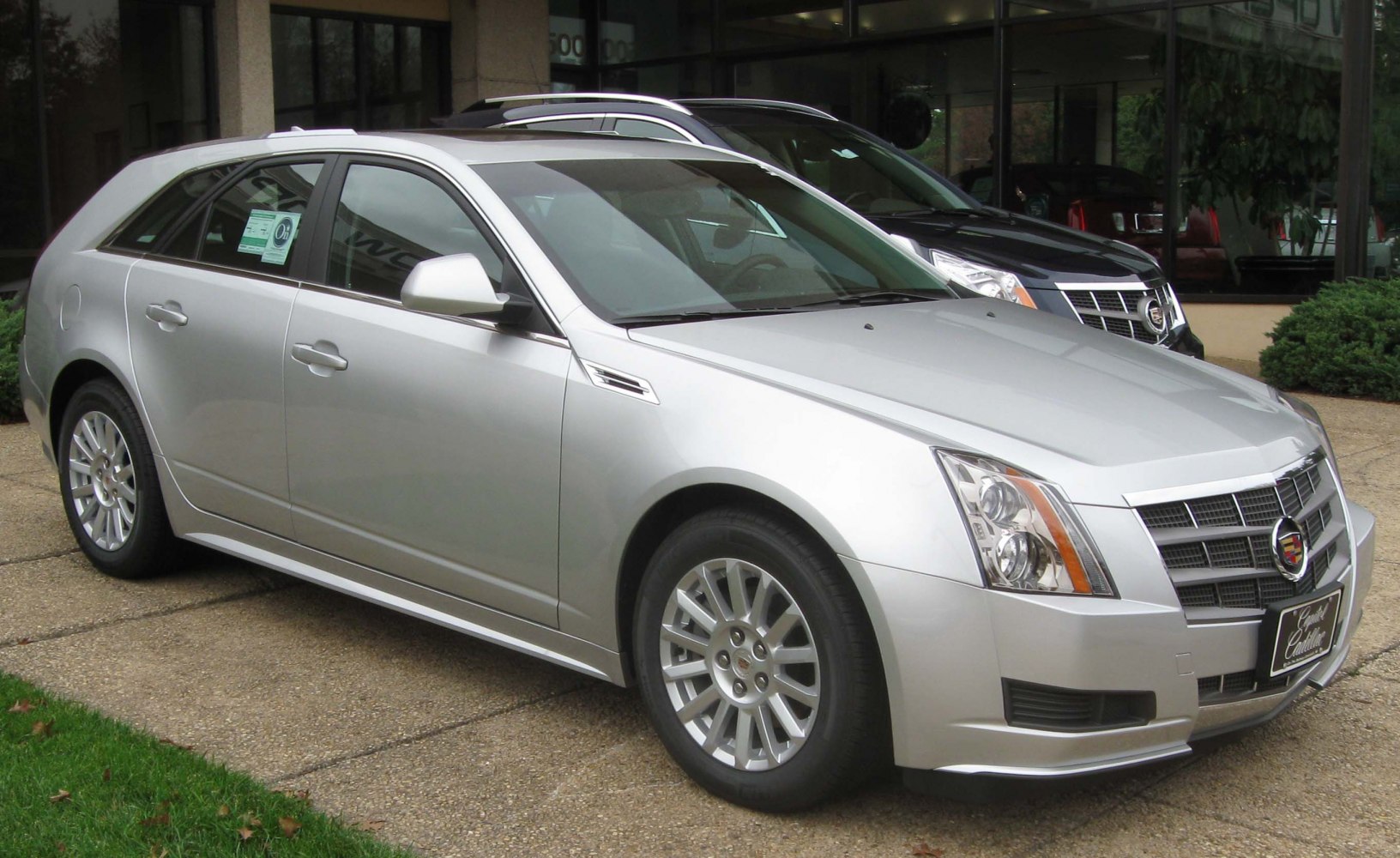 Silver sport wagon with angular headlights and chrome grille