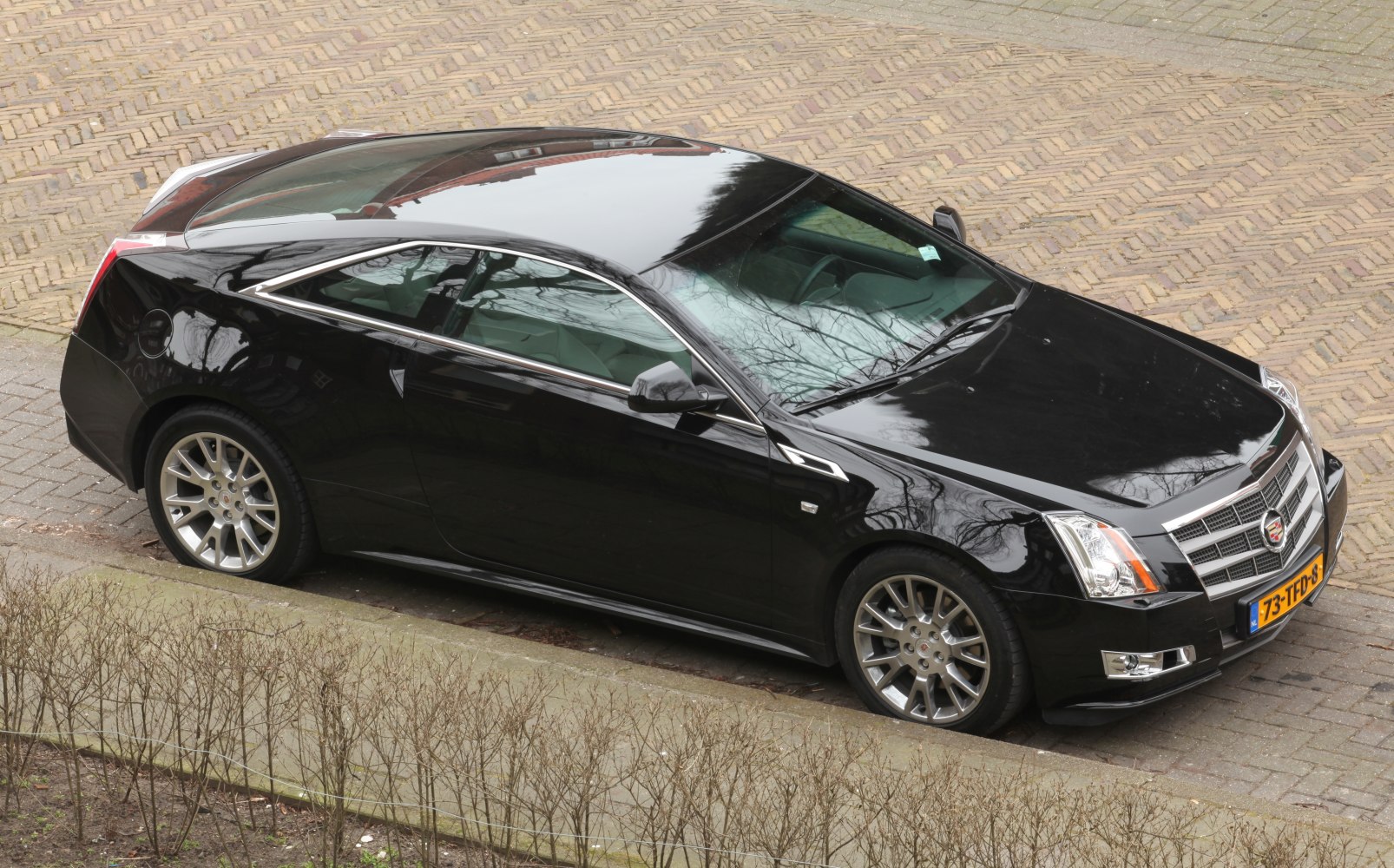 Black luxury coupe with aerodynamic body and alloy wheels