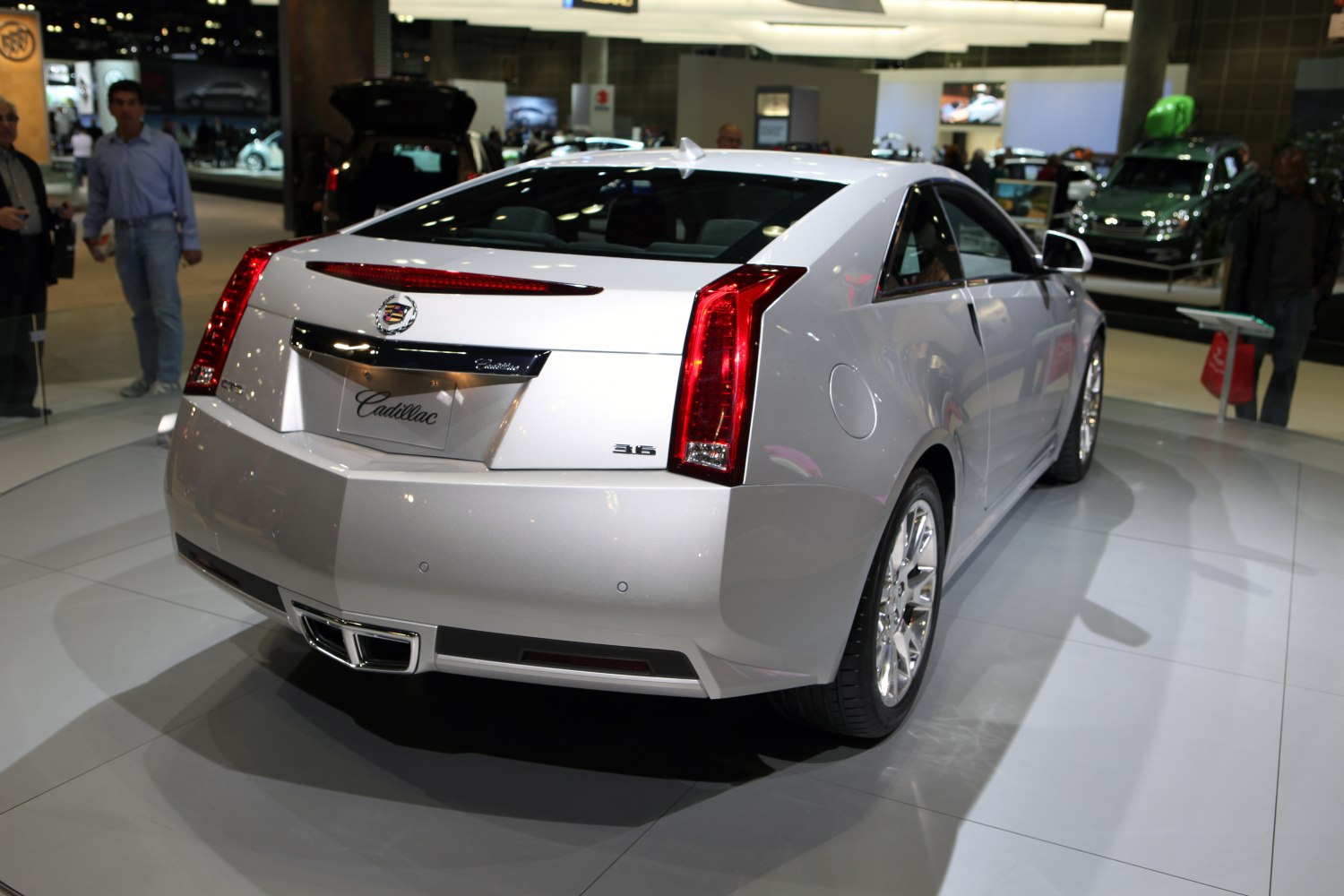 Rear view of a coupe with vertical tail lights and chrome exhaust