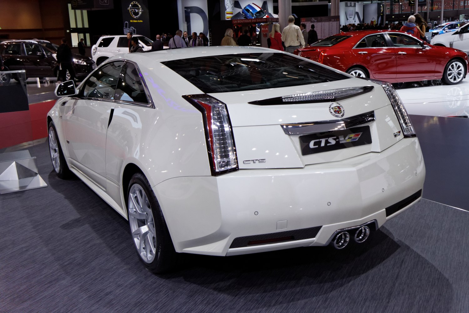 White coupe rear view with vertical taillights and dual exhaust