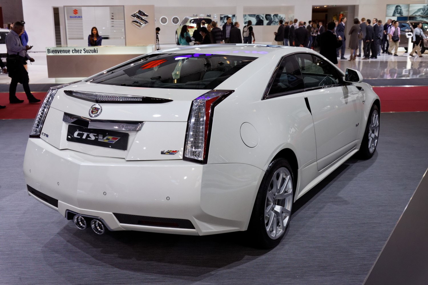 White coupe rear with vertical taillights and dual exhaust