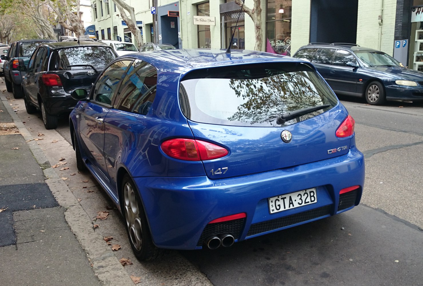 Rear view of sporty hatchback with dual exhaust and distinct taillights