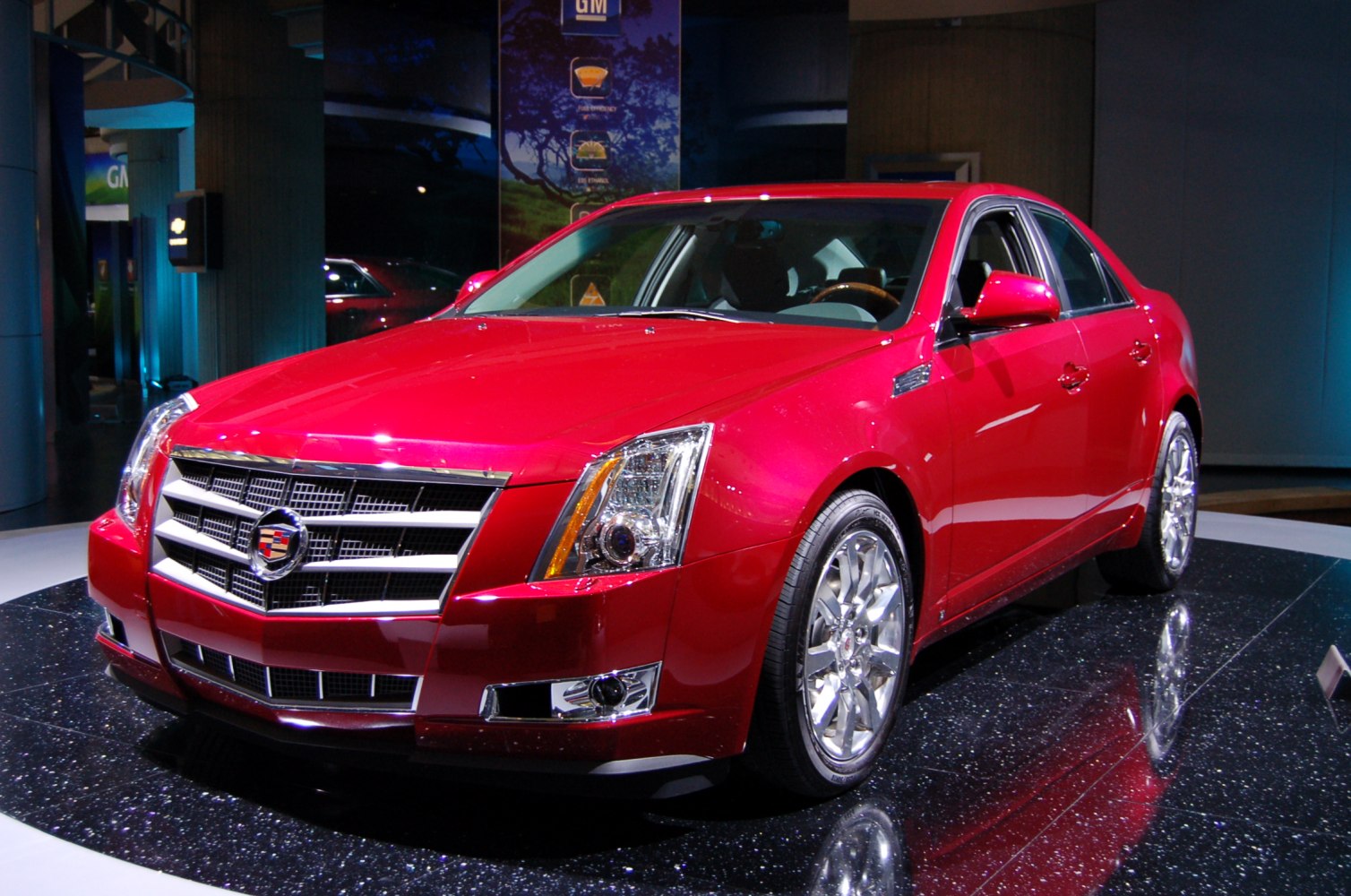 Front grille and headlight design with chrome wheels, sleek sedan profile