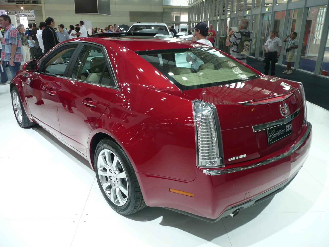 Rear and side view of a luxury sedan with vertical tail lights and smooth body lines.