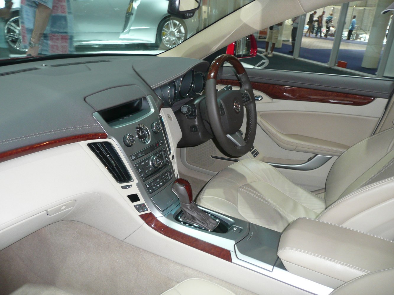 Beige leather seats, wood trim details, modern gear shift console