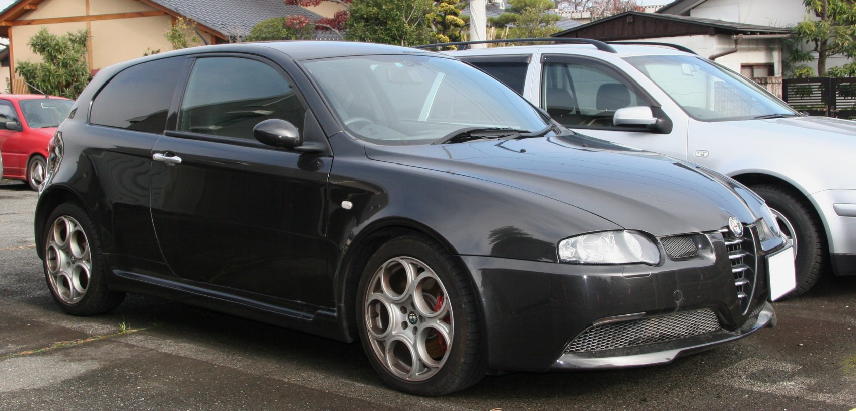 Black sporty hatchback with distinctive front grille and alloy wheels