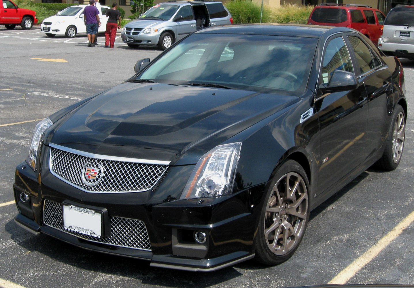 Luxury sedan front mesh grille and multi-spoke alloy wheels