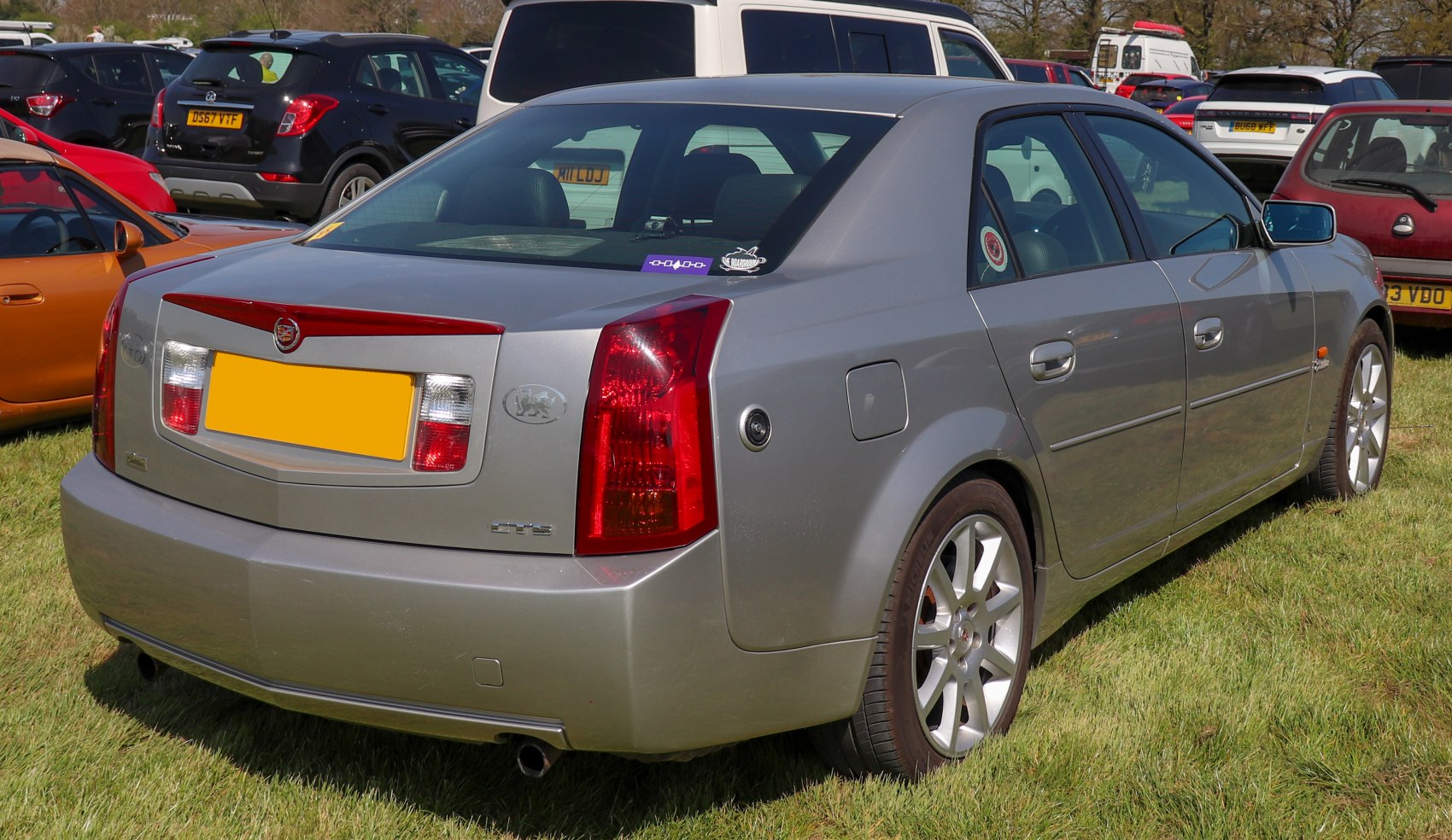 Rear and side view of silver luxury sedan with distinctive taillights and alloy wheels