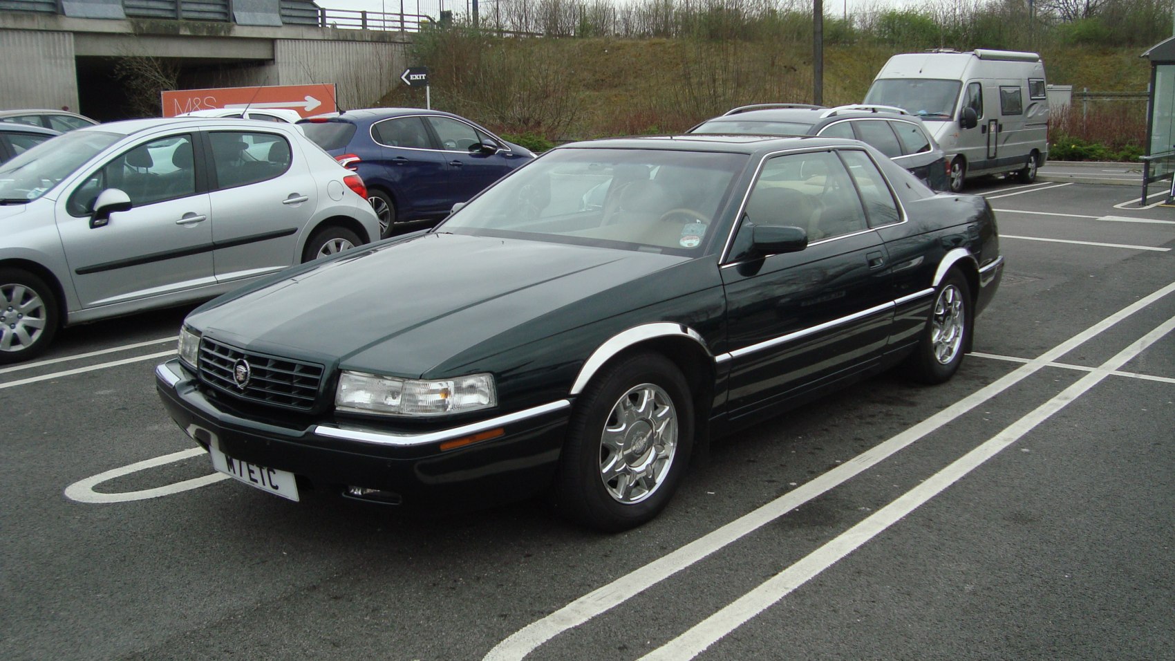 Classic 1990s coupe with chrome fenders and alloy wheels