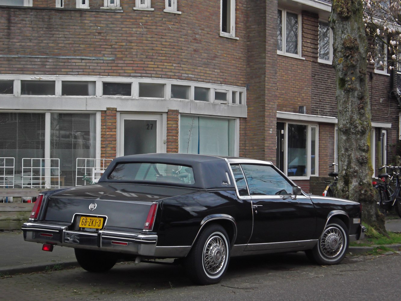 Luxury coupe with vinyl roof and wire spoke wheels