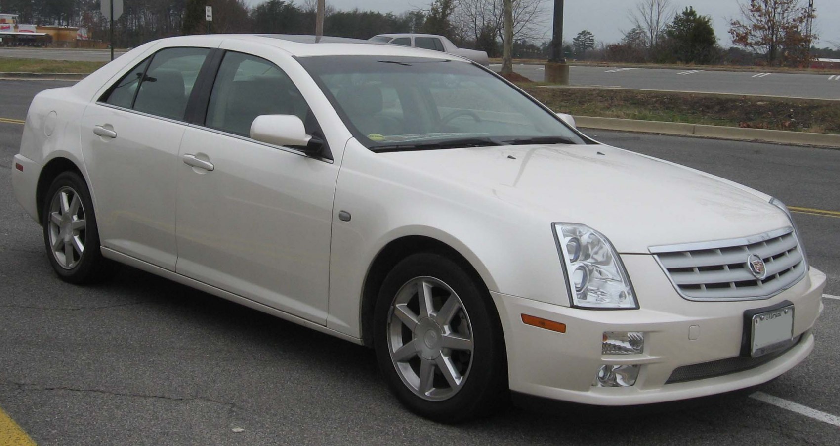 Front view of white sedan with distinct grille and multi-lens headlights