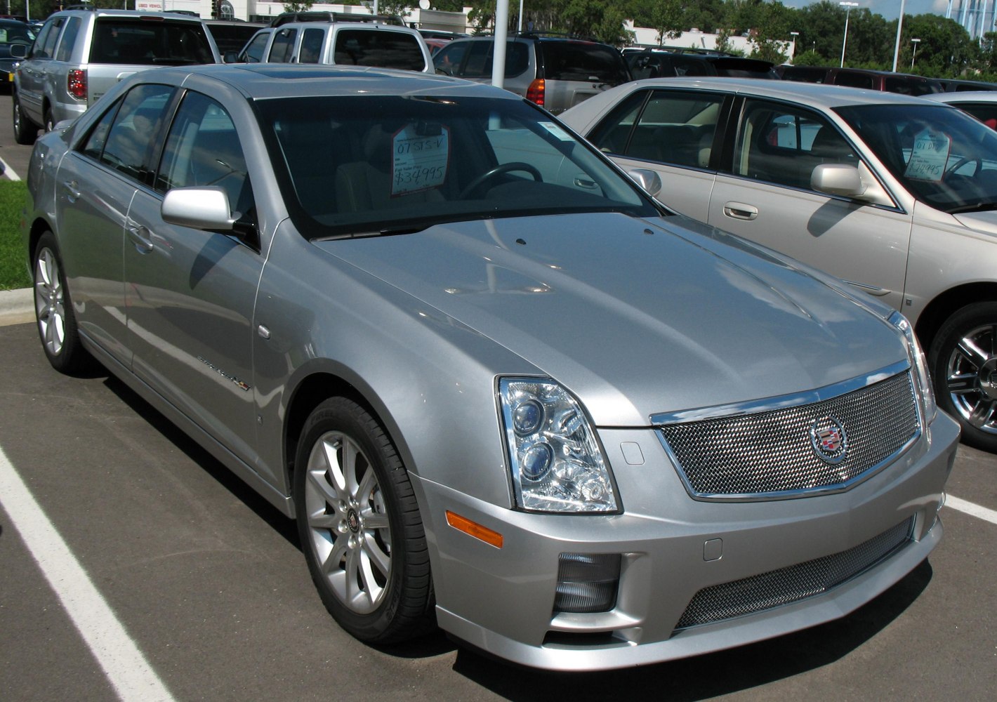 Silver luxury sedan with mesh grille and multi-lens headlights
