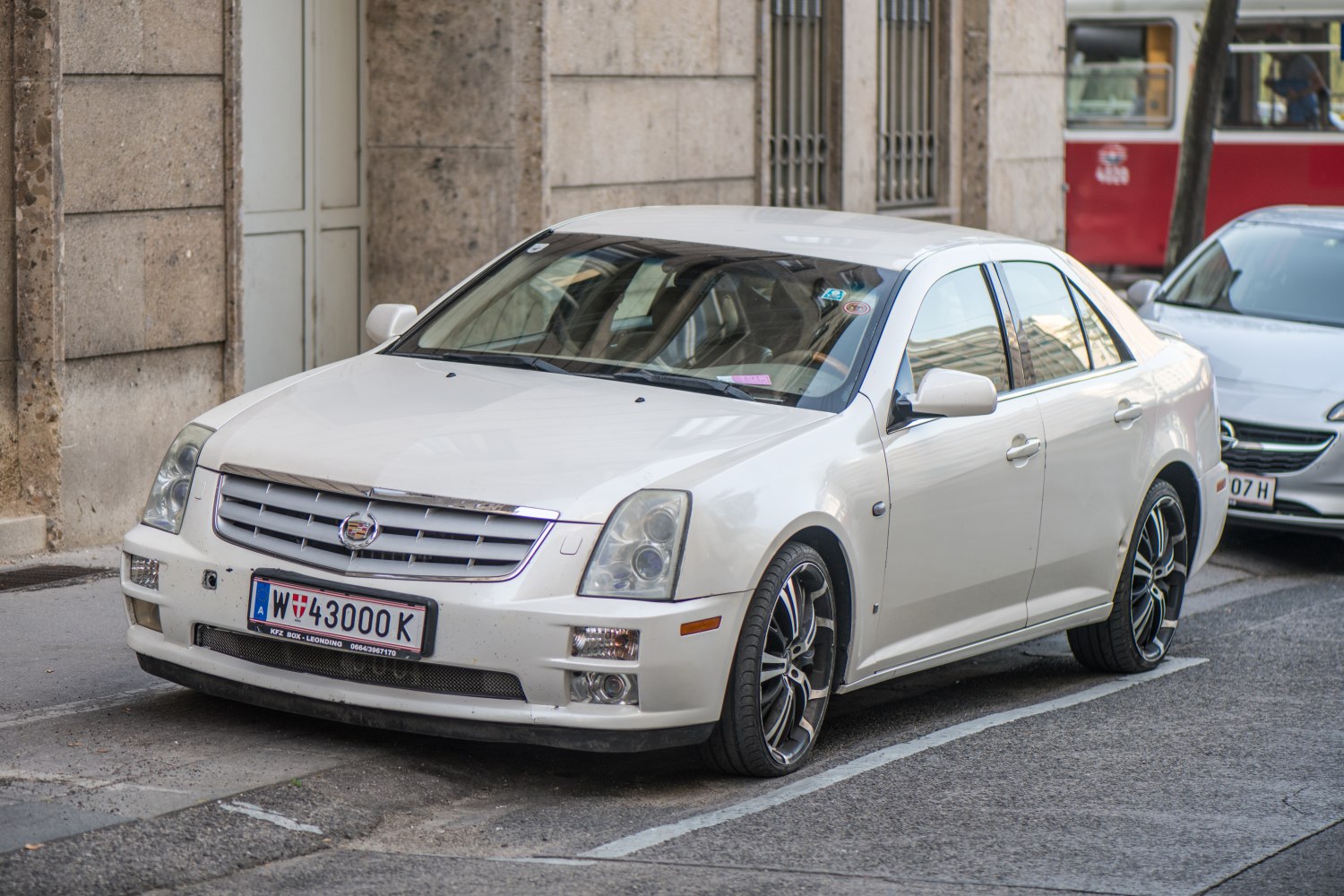 Front view of a luxury sedan with distinctive grille and multi-lens headlights