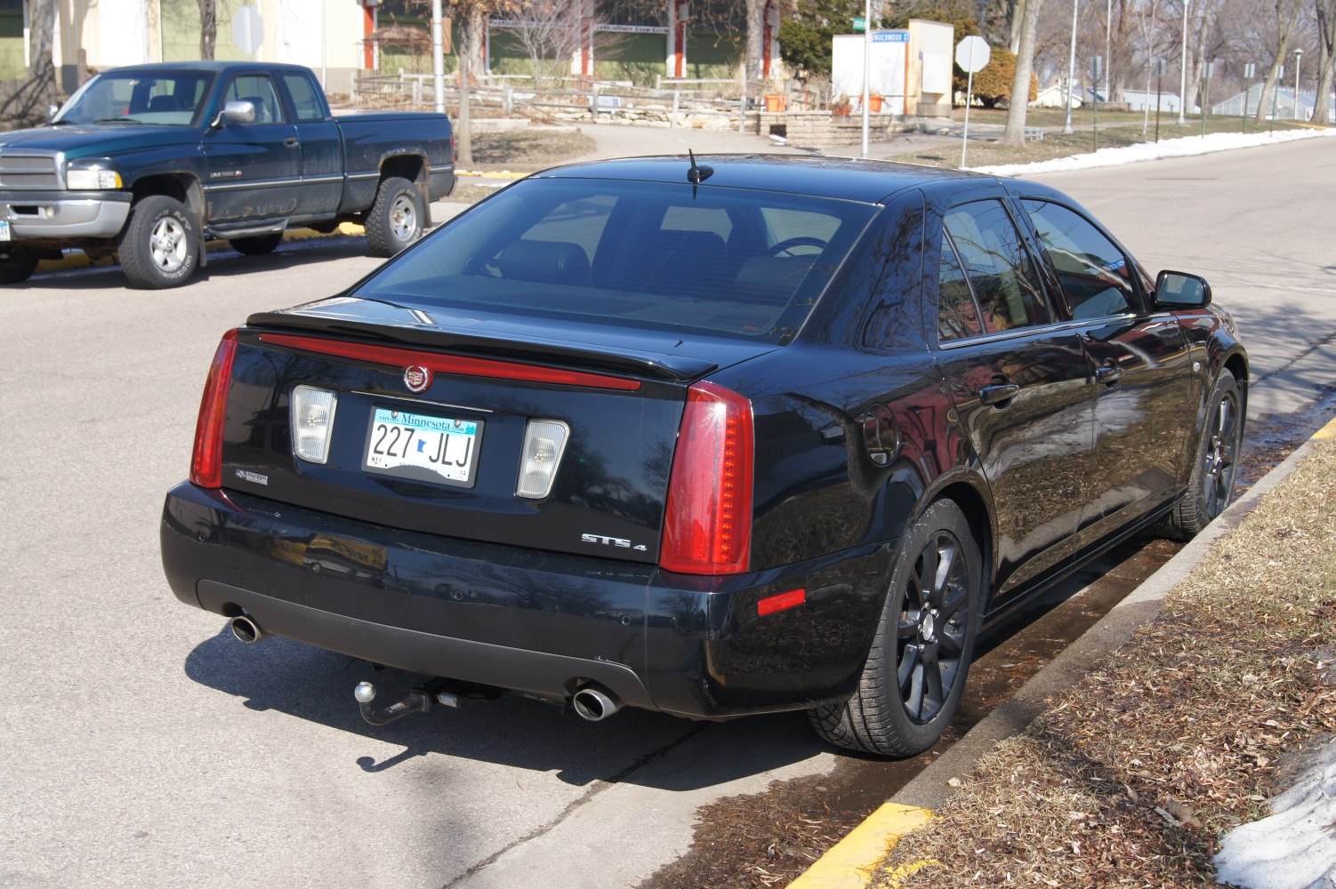 Rear view with dual exhaust, LED tail lights, and black alloy wheels